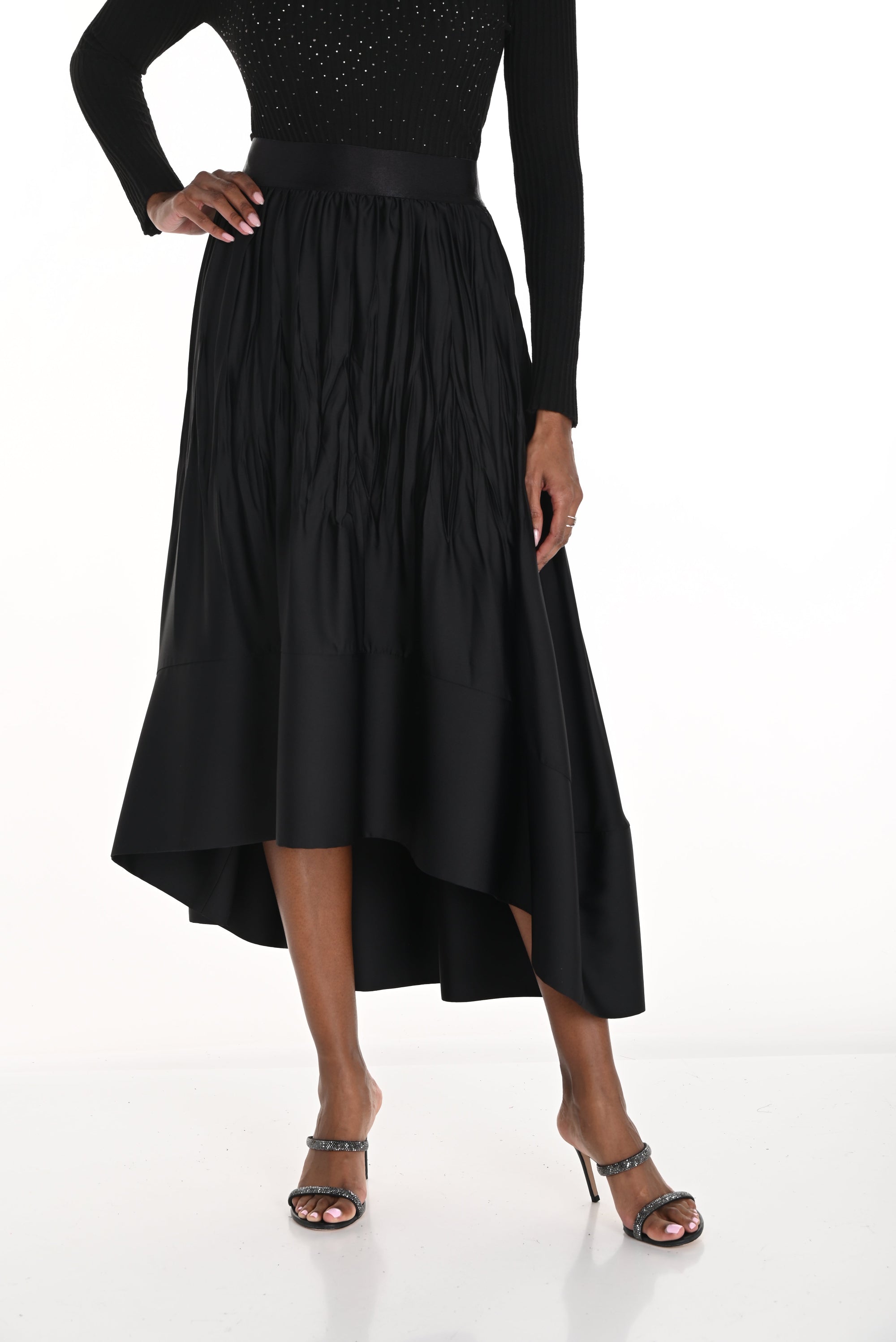 high low pleated black skirt worn by model