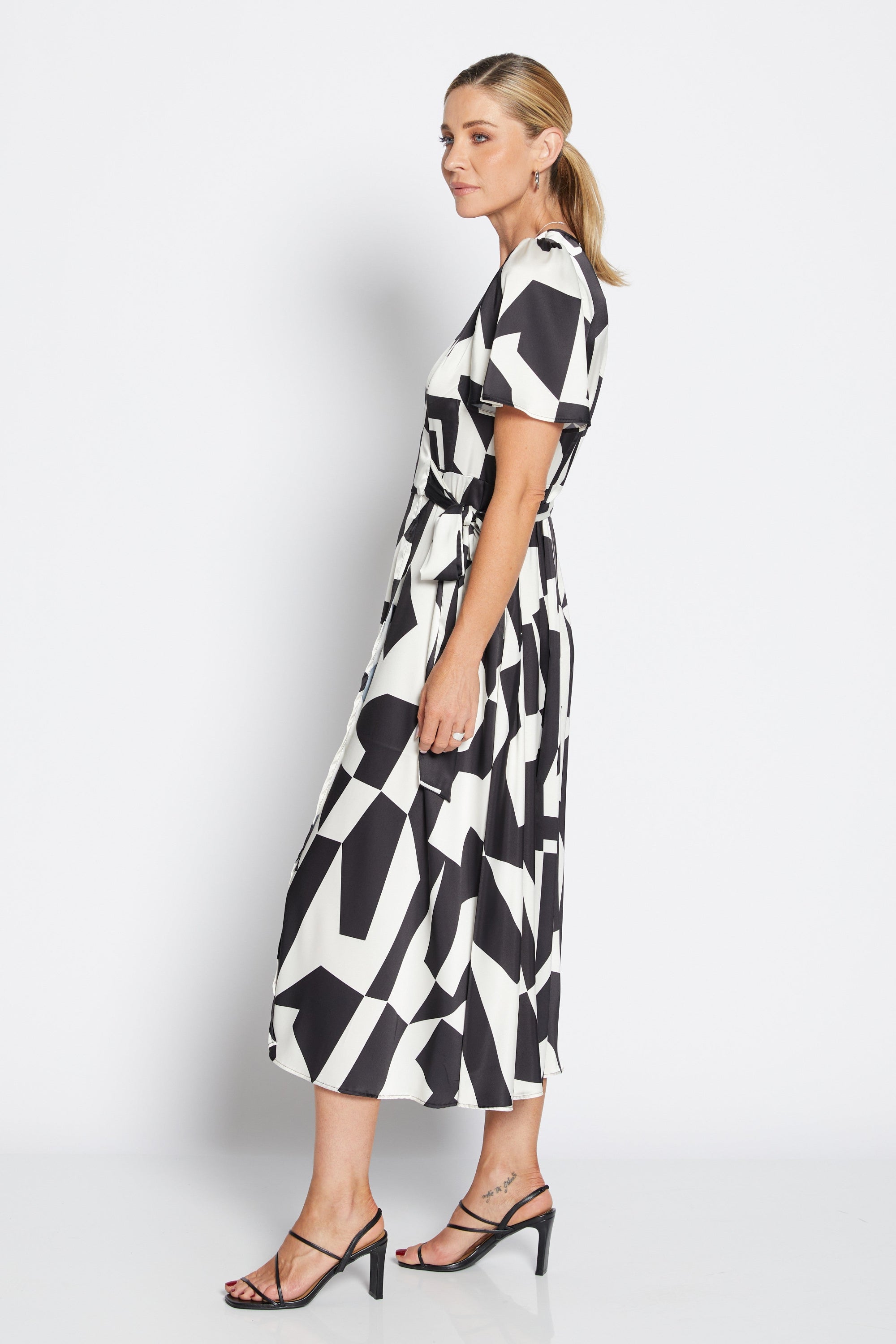 womens wrap midi dress black white geometric print worn by model side view