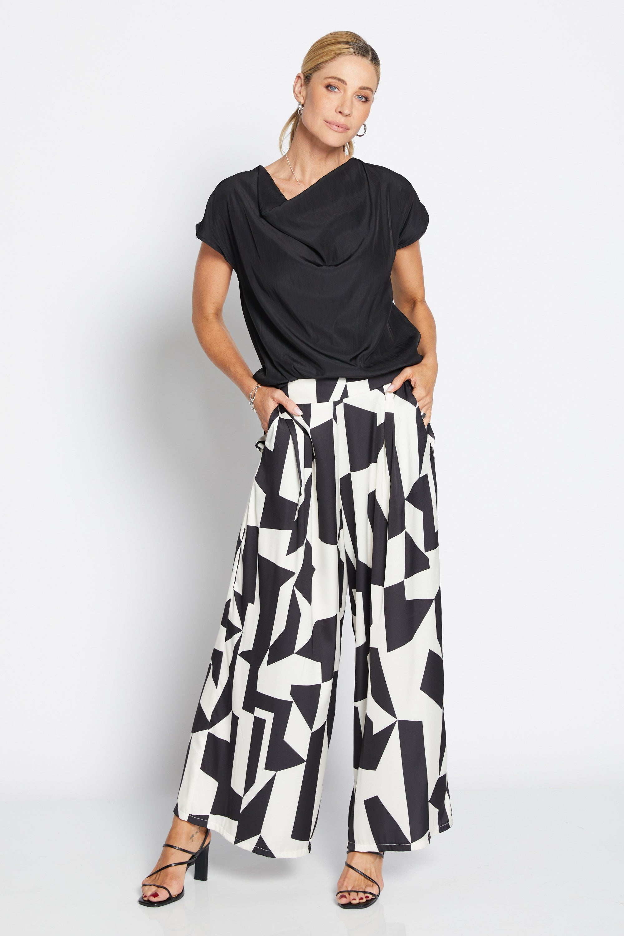Womens wide leg black white geometric pant with black top worn by model 