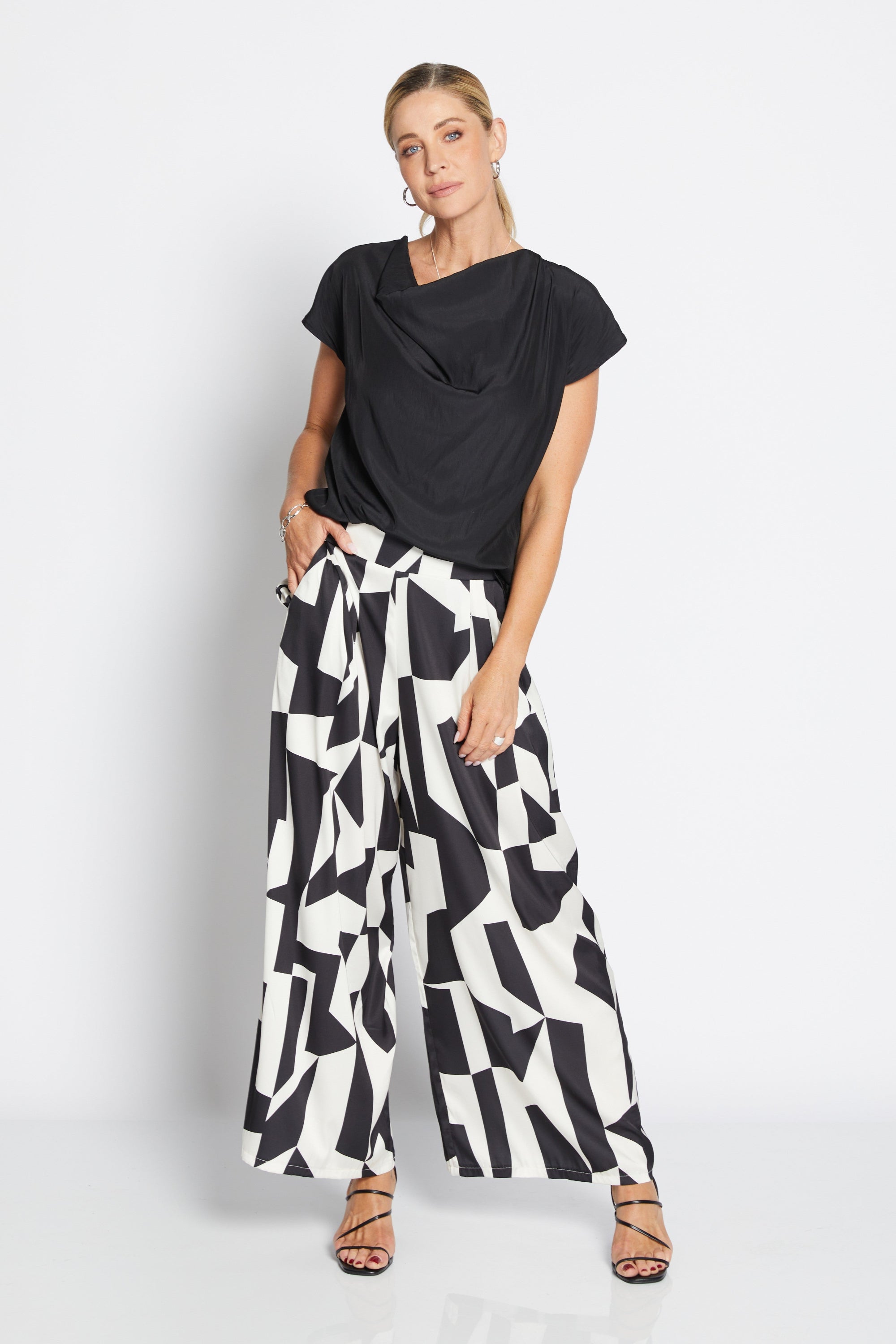 Womens wide leg black white geometric pant with black top worn by model 