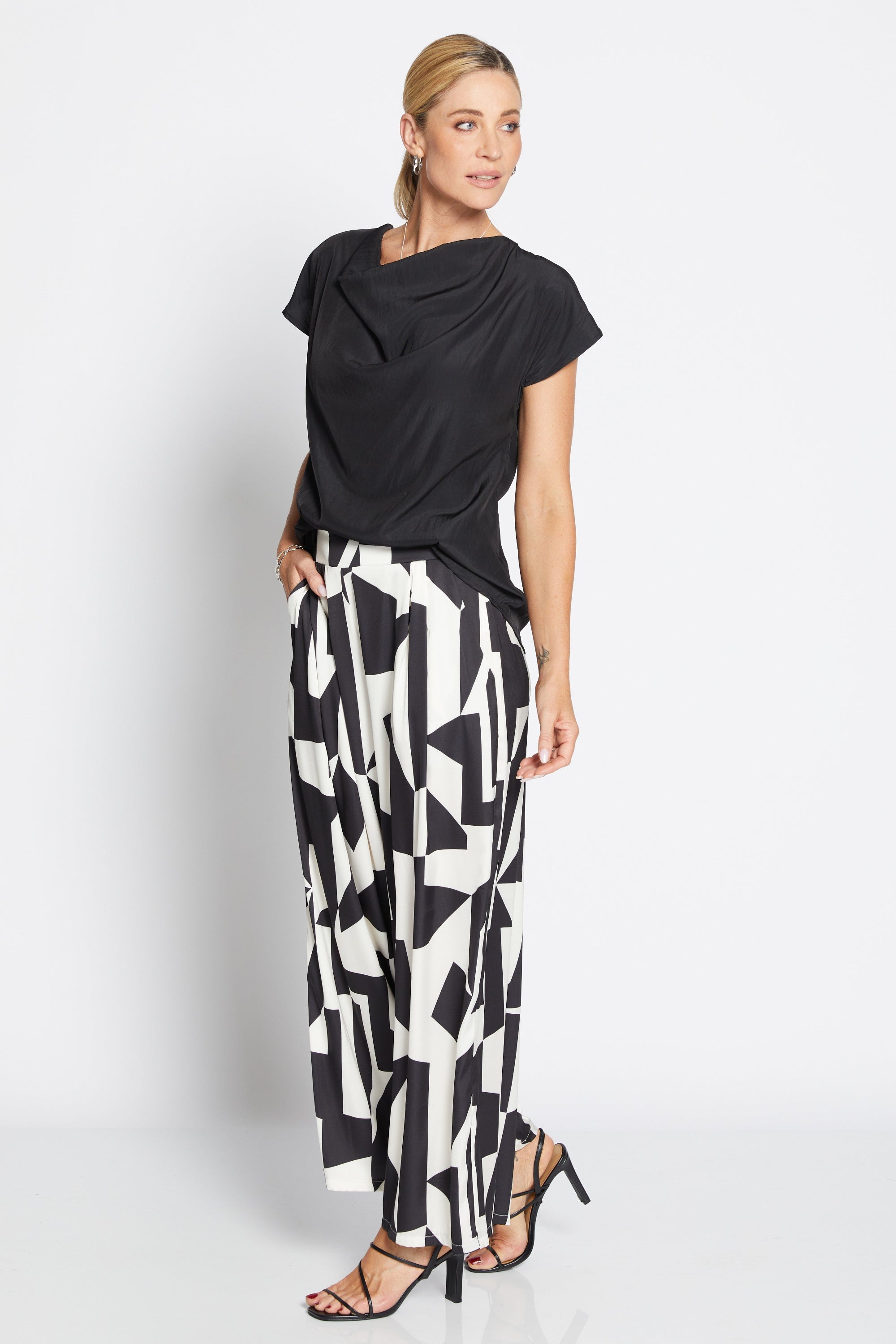 Womens wide leg black white geometric pant with black top worn by model 
