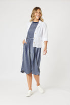 boxy linen blazer in white with stripe dress worn by model 
