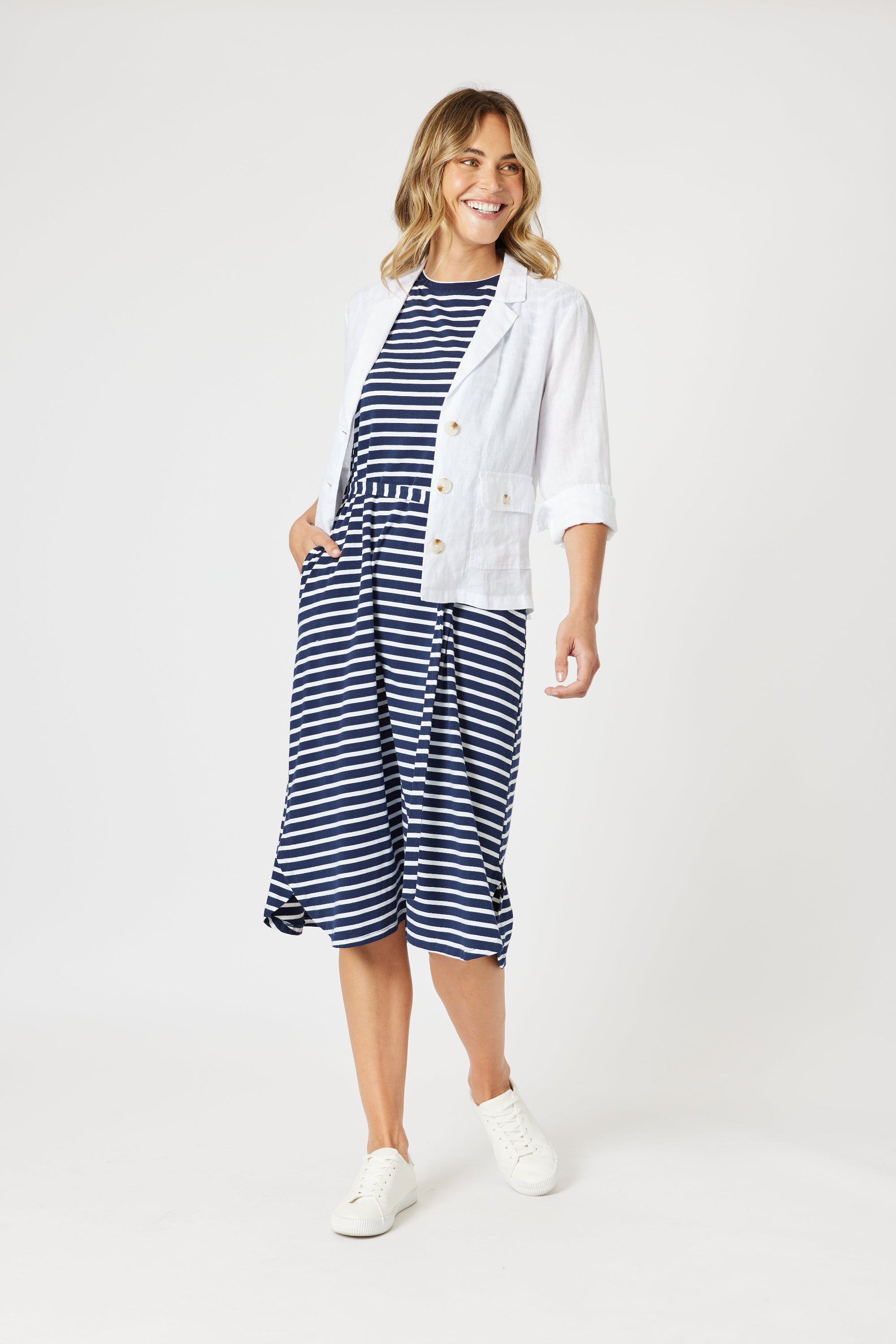 boxy linen blazer in white with stripe dress worn by model 