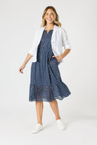 boxy linen blazer in white with polka dot dress worn by model 