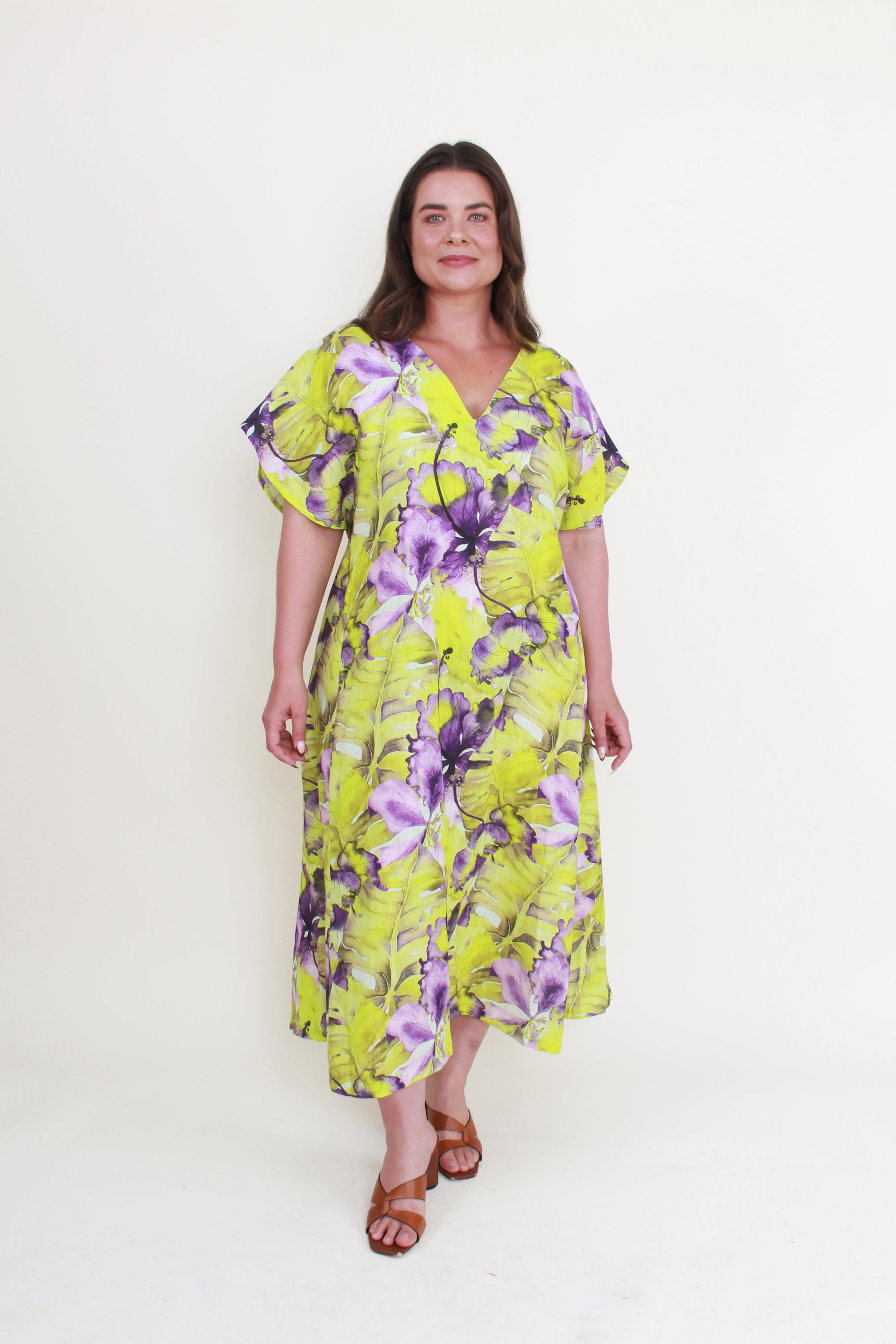 Woman wearing a floral dress with a white background