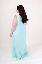 Woman wearing a light blue dress against a white background