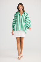 green and white vertical stripe shirt and white short worn by model 