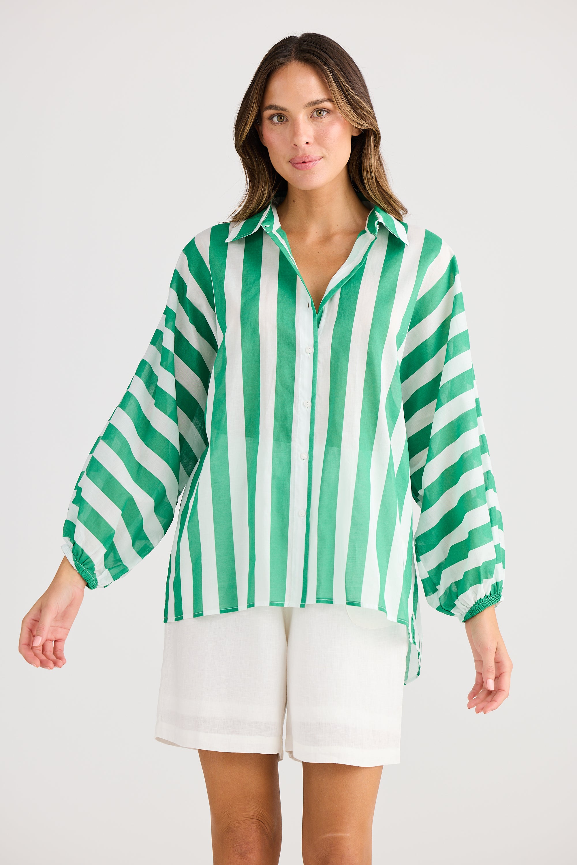 green and white vertical stripe shirt worn by model 
