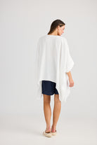 oversized high low white top with navy shorts worn by model back view