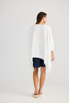 oversized high low white top with navy shorts worn by model back view
