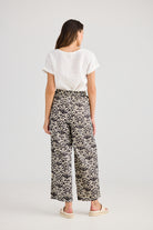 Wide leg pant cream and black fan print and white tee worn by model back view