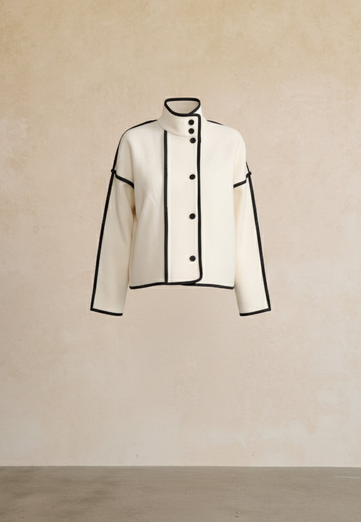 White jacket with black accents on a beige background