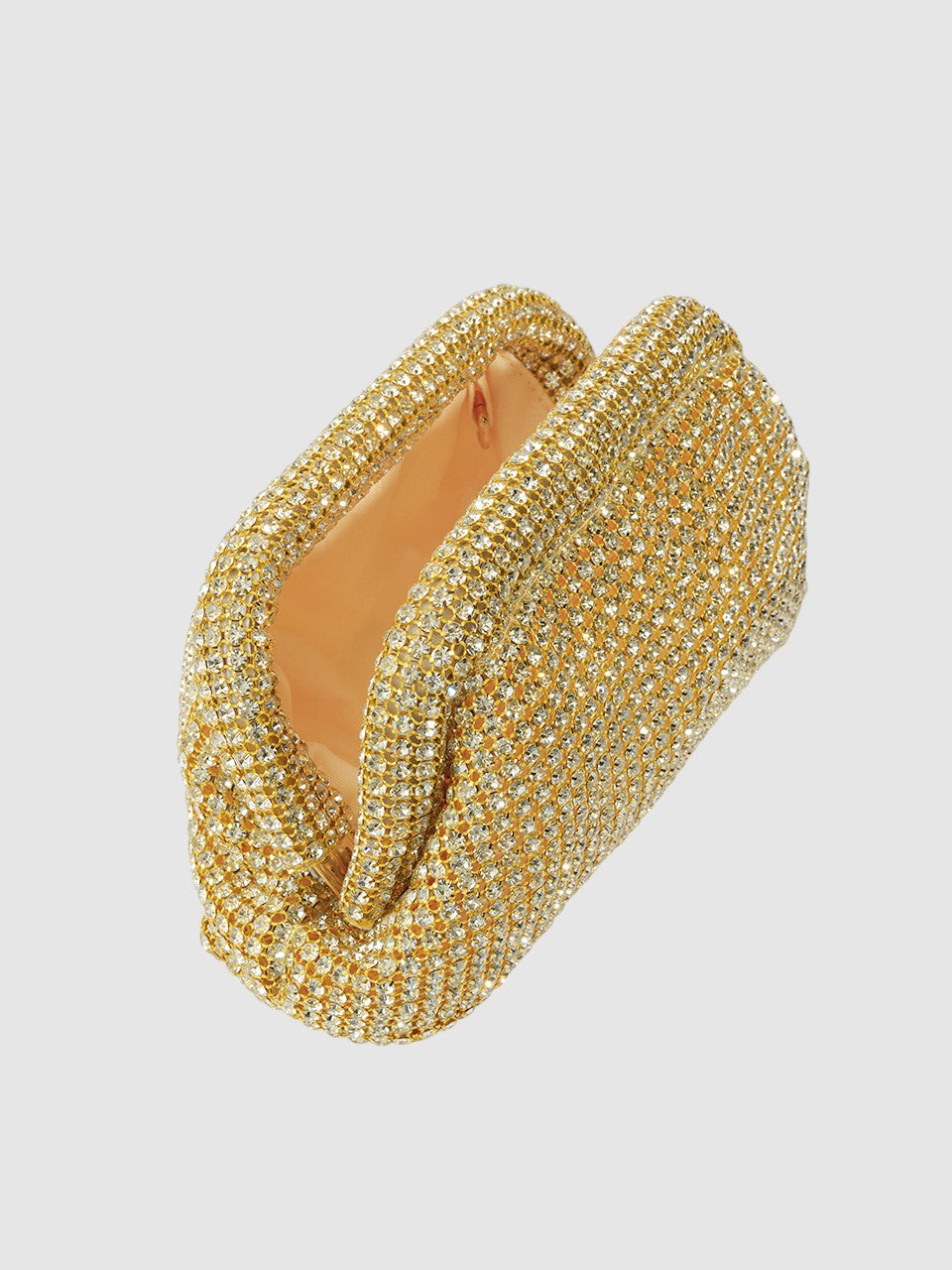 Gold bracelet with intricate design on a light gray background