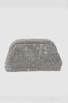 Silver clutch bag with rhinestone embellishments on a light gray background