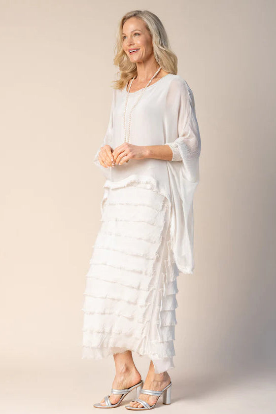 Woman wearing a white outfit with a plain background