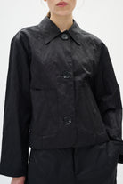 Person wearing a black jacket on a white background
