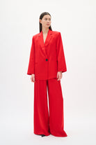 Woman wearing a red suit on a white background