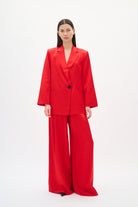 Woman wearing a red suit on a white background