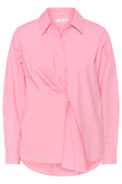Pink shirt with a tie detail on a white background