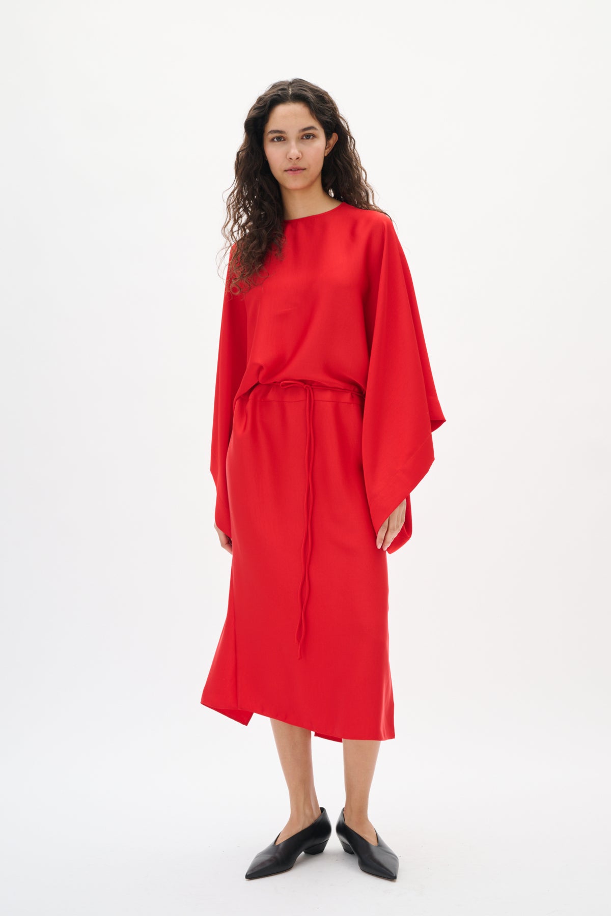 Woman wearing a red outfit on a white background