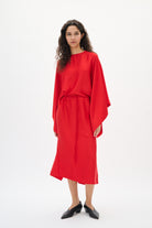 Woman wearing a red outfit on a white background