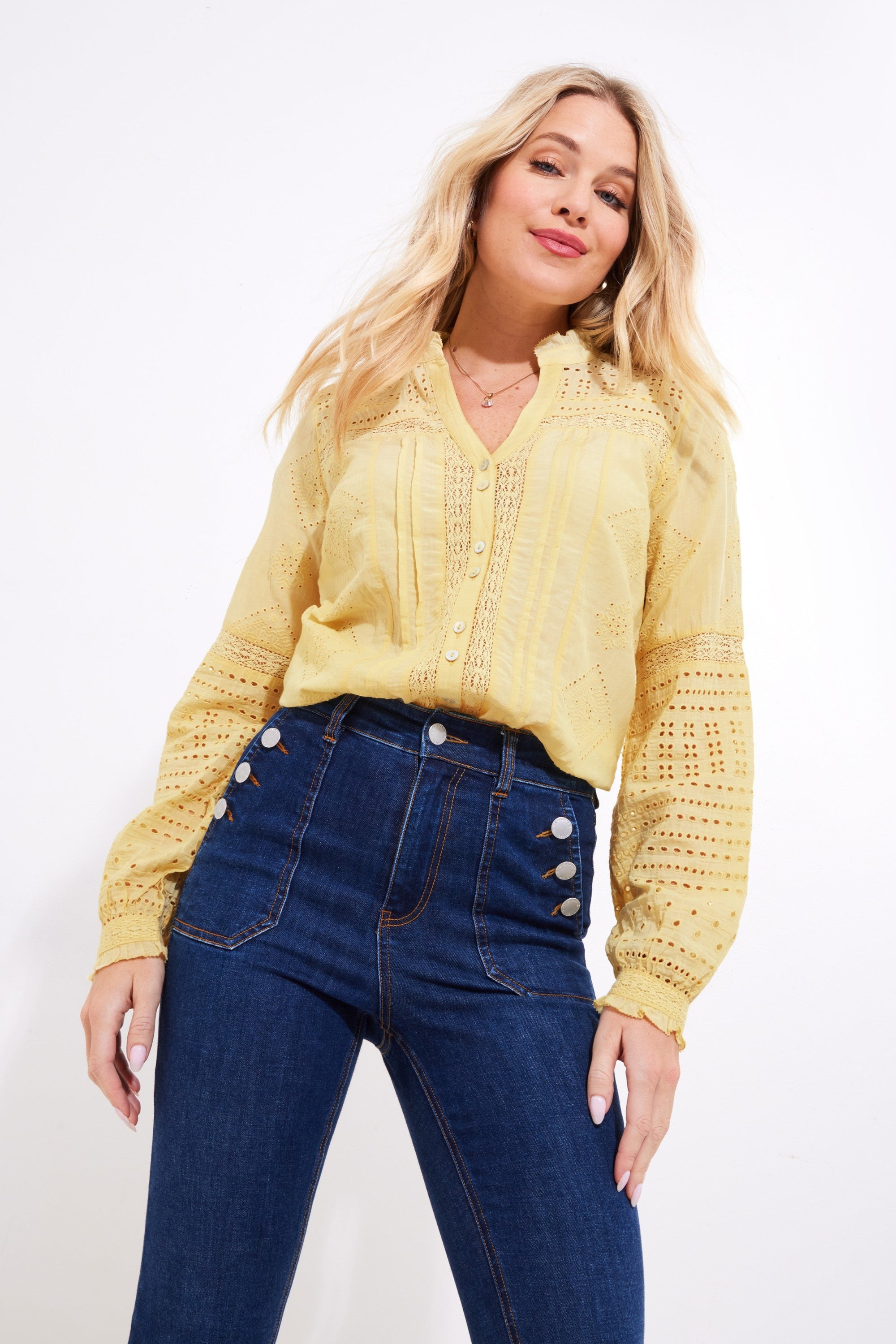 yellow broderie blouse with jeans worn by model 