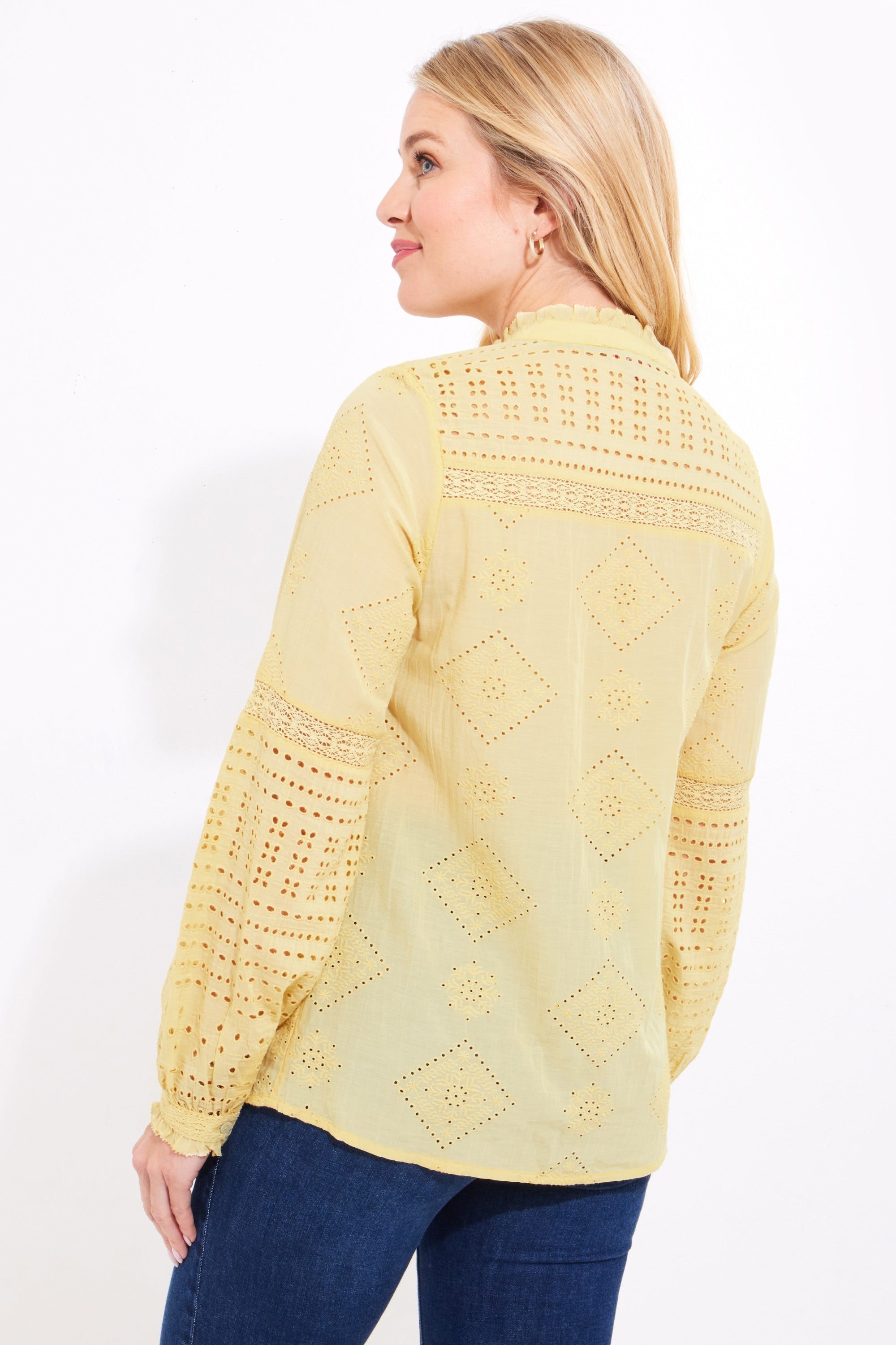 yellow broderie blouse with jeans worn by model back view
