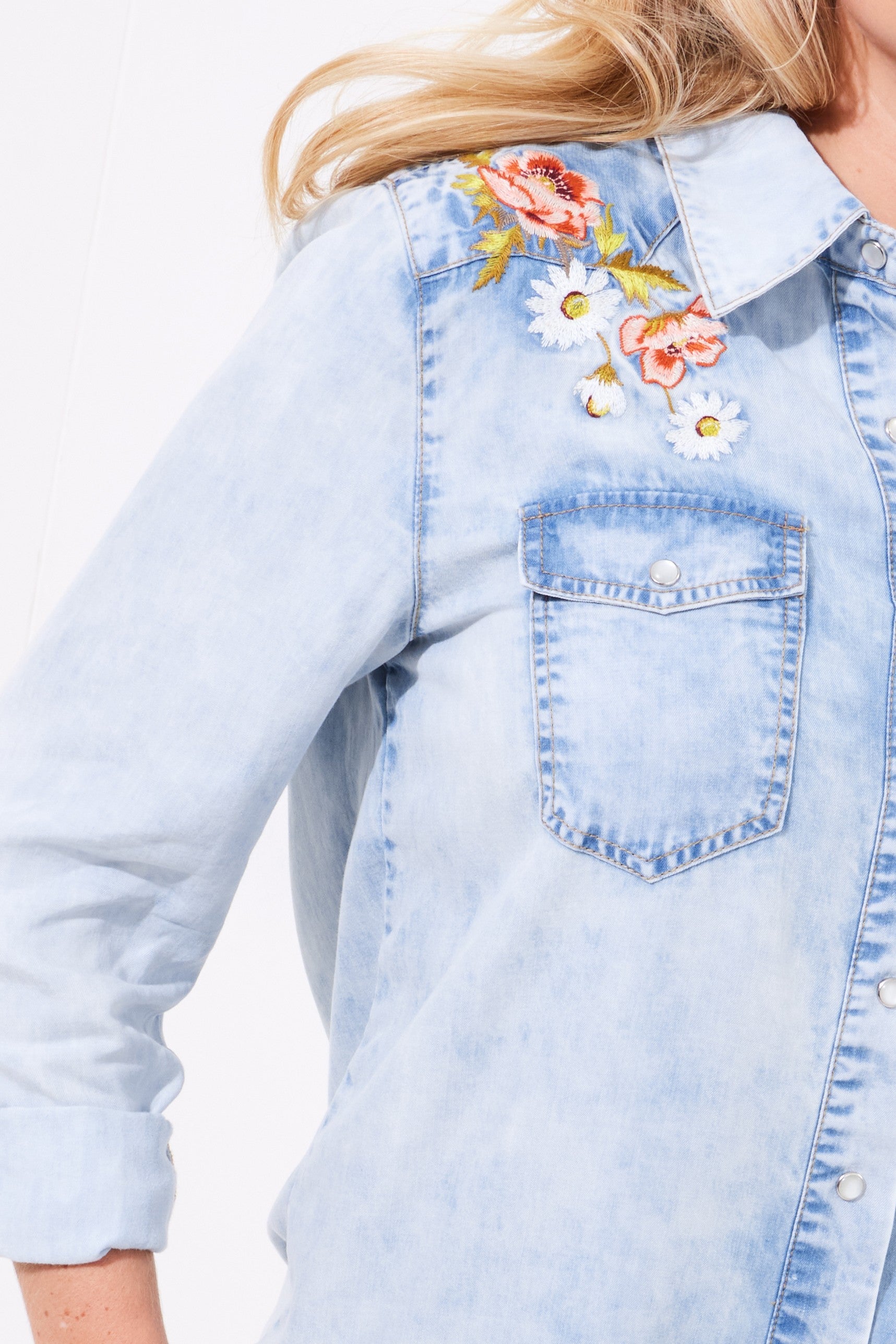 denim shirt floral embroidery worn by model close up 