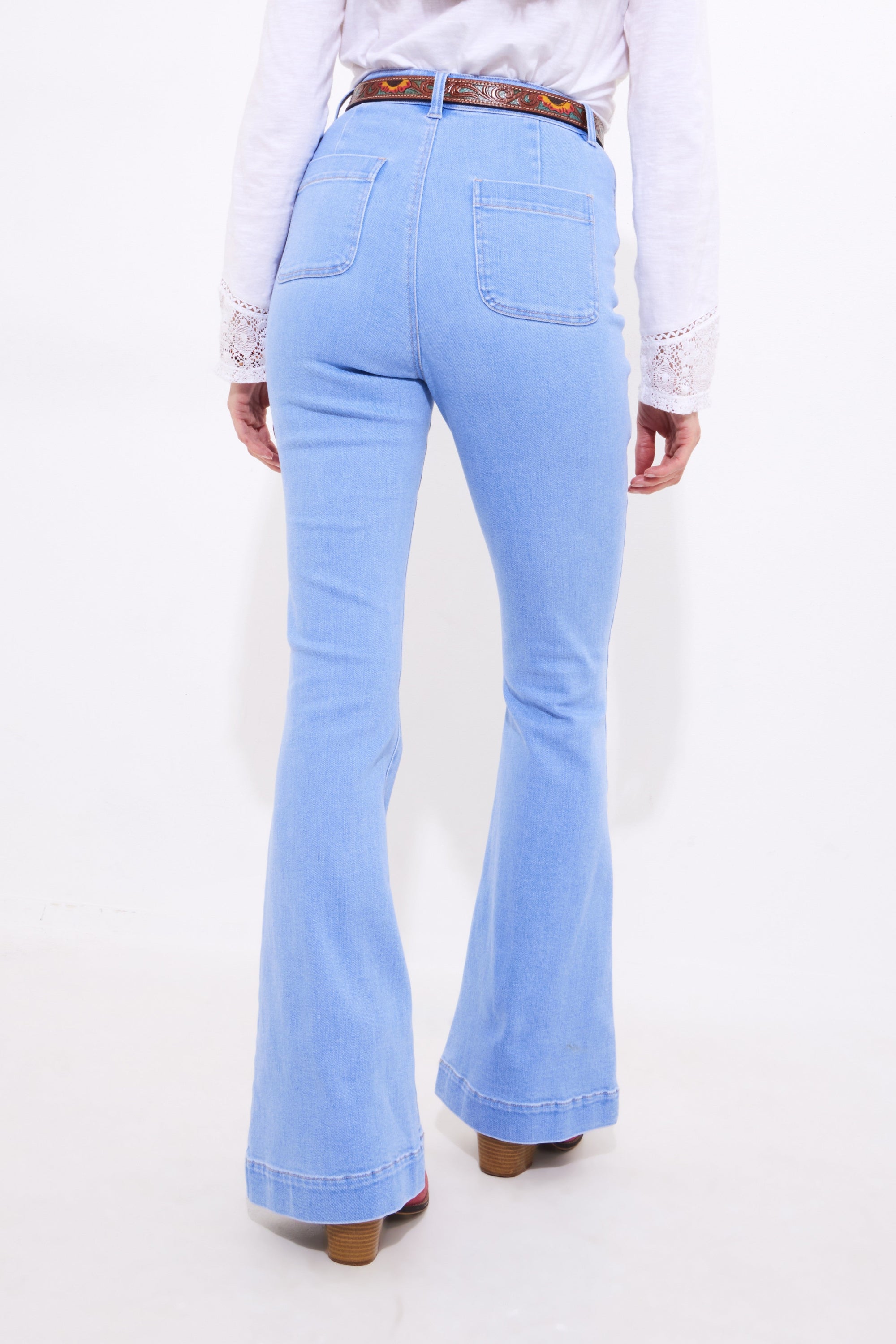 light wash denim flare jean worn by model  back view