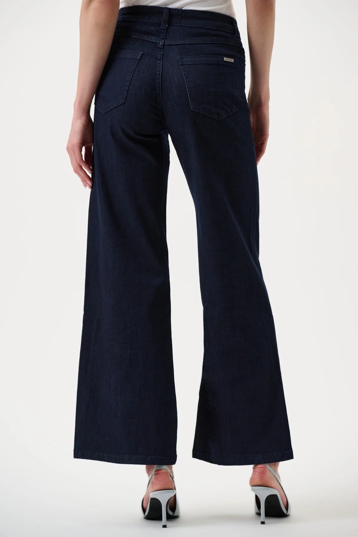 Navy blue pants worn by a person on a white background back angle