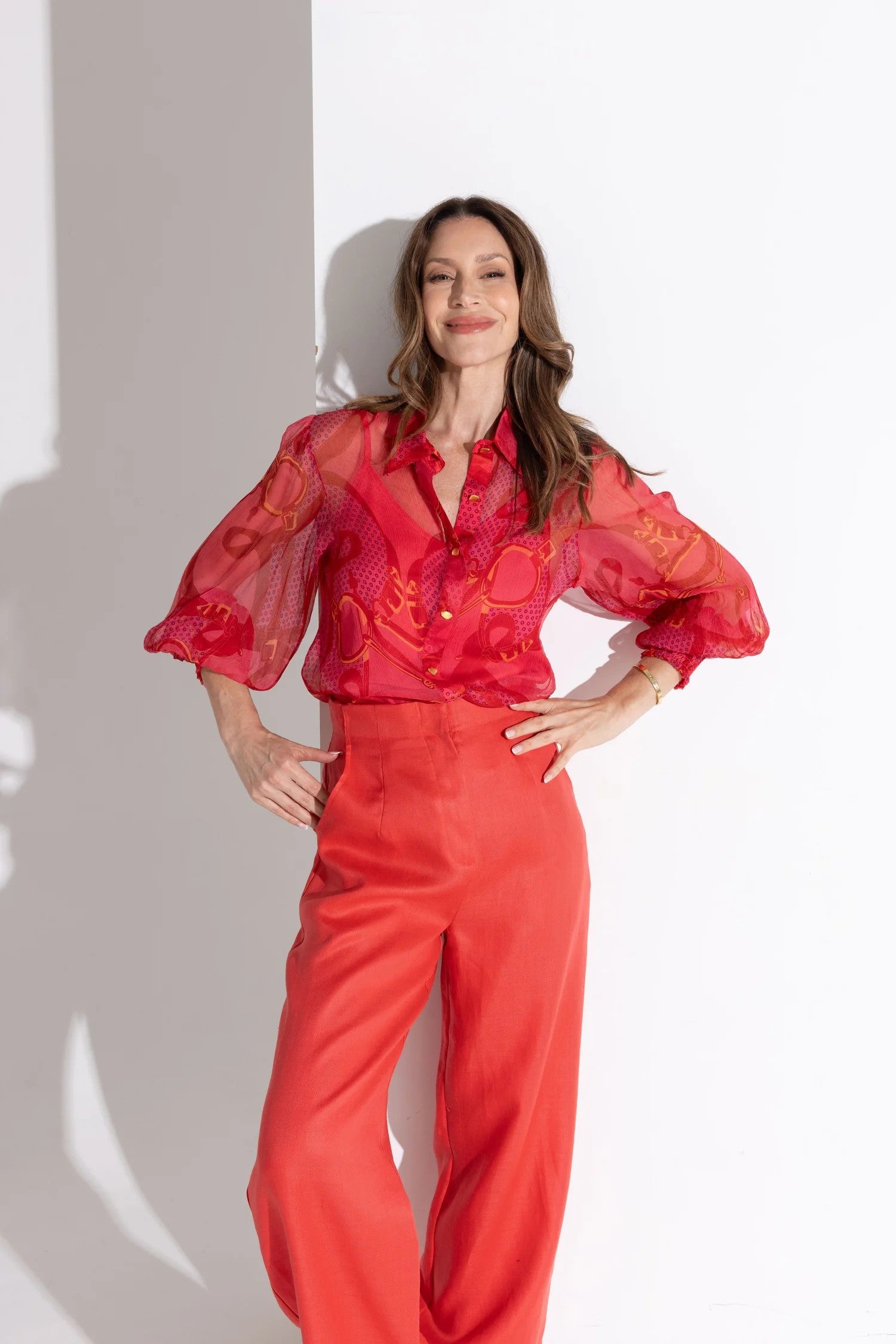 printed reds silk blouse and red pant worn by model 