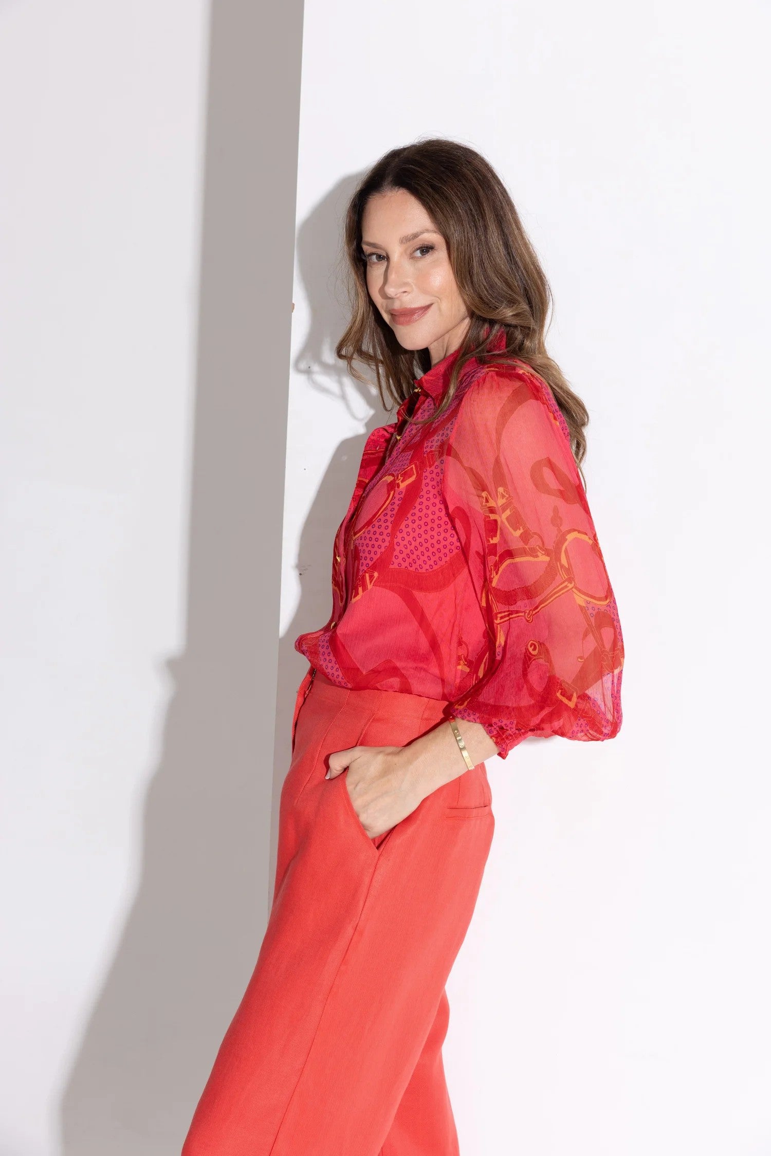 printed reds silk blouse and red pant worn by model side view
