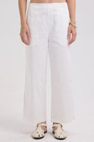White wide-leg pants worn by a person on a white background