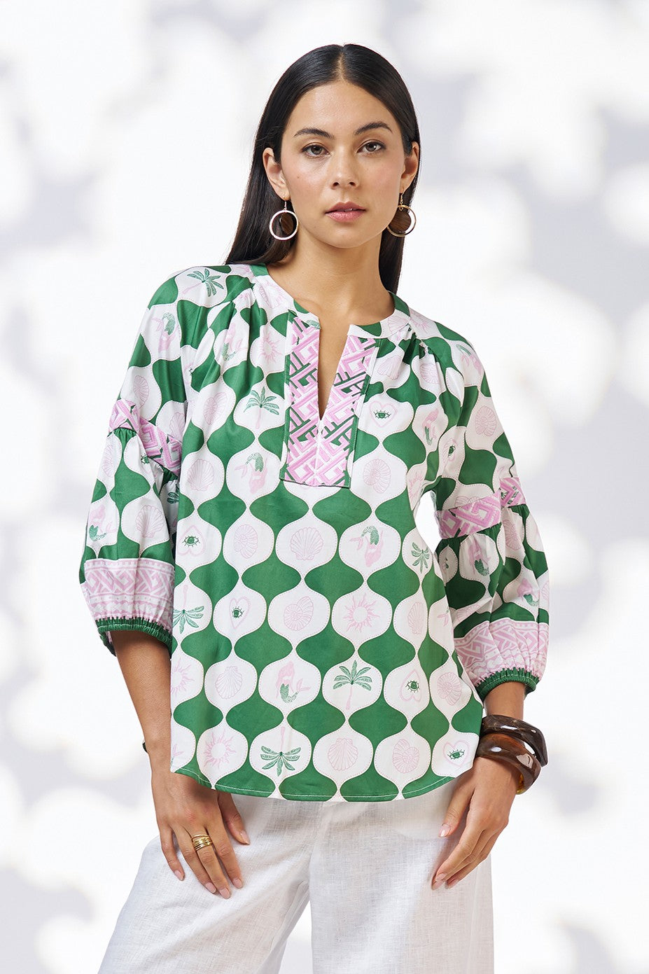 model wearing green white and pink patterned blouse