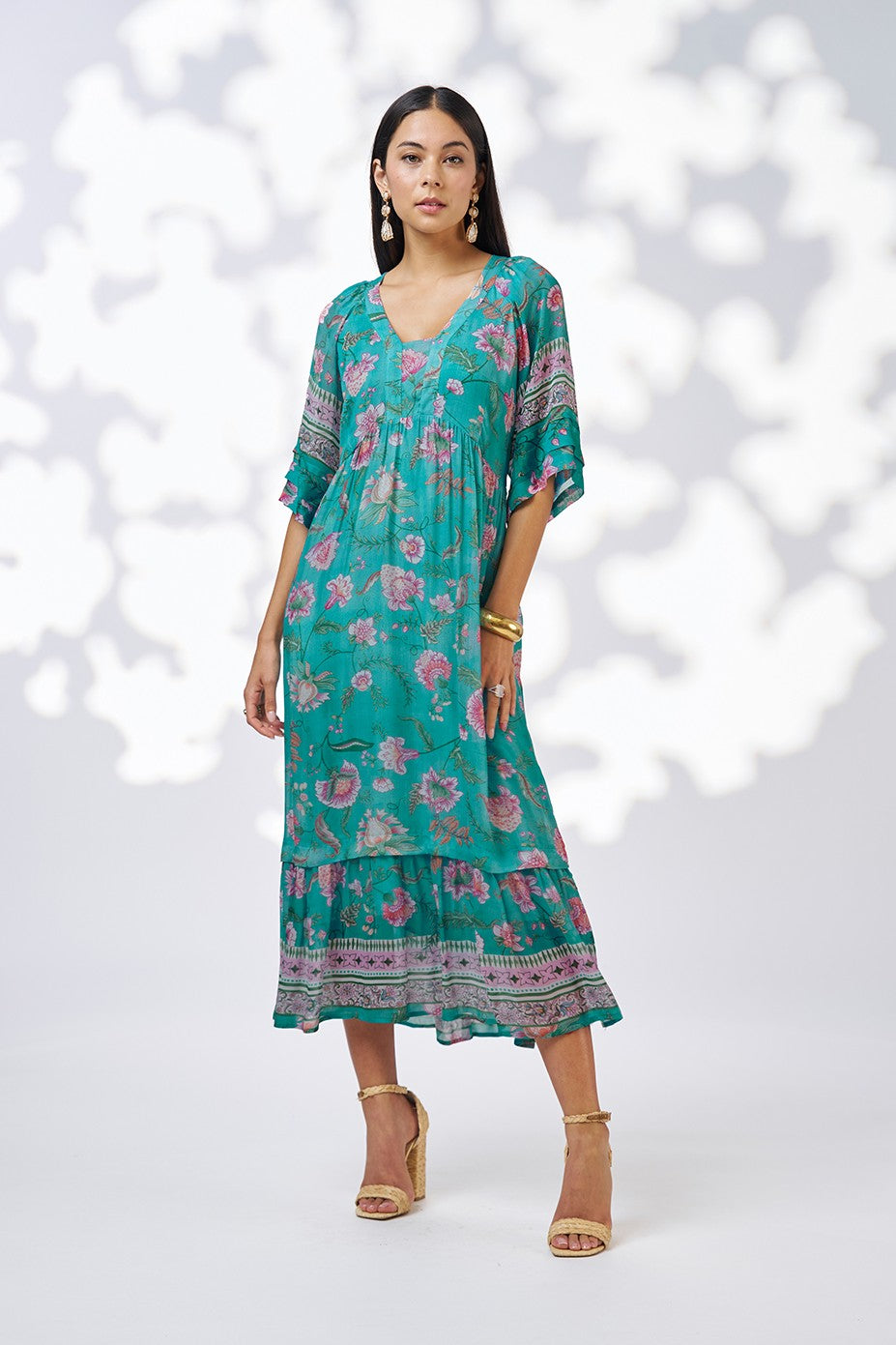 midi dress in aqua floral print worn by model
