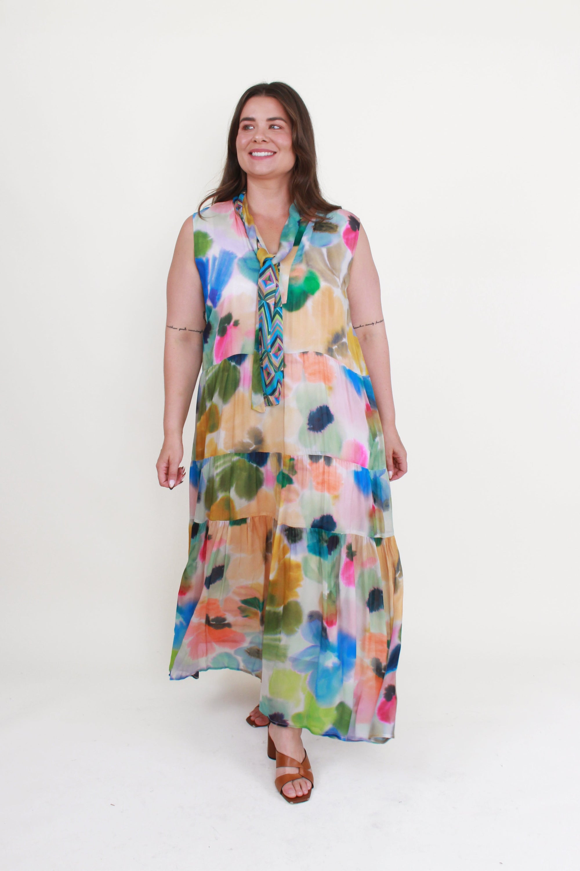 Woman wearing a colorful floral dress on a white background