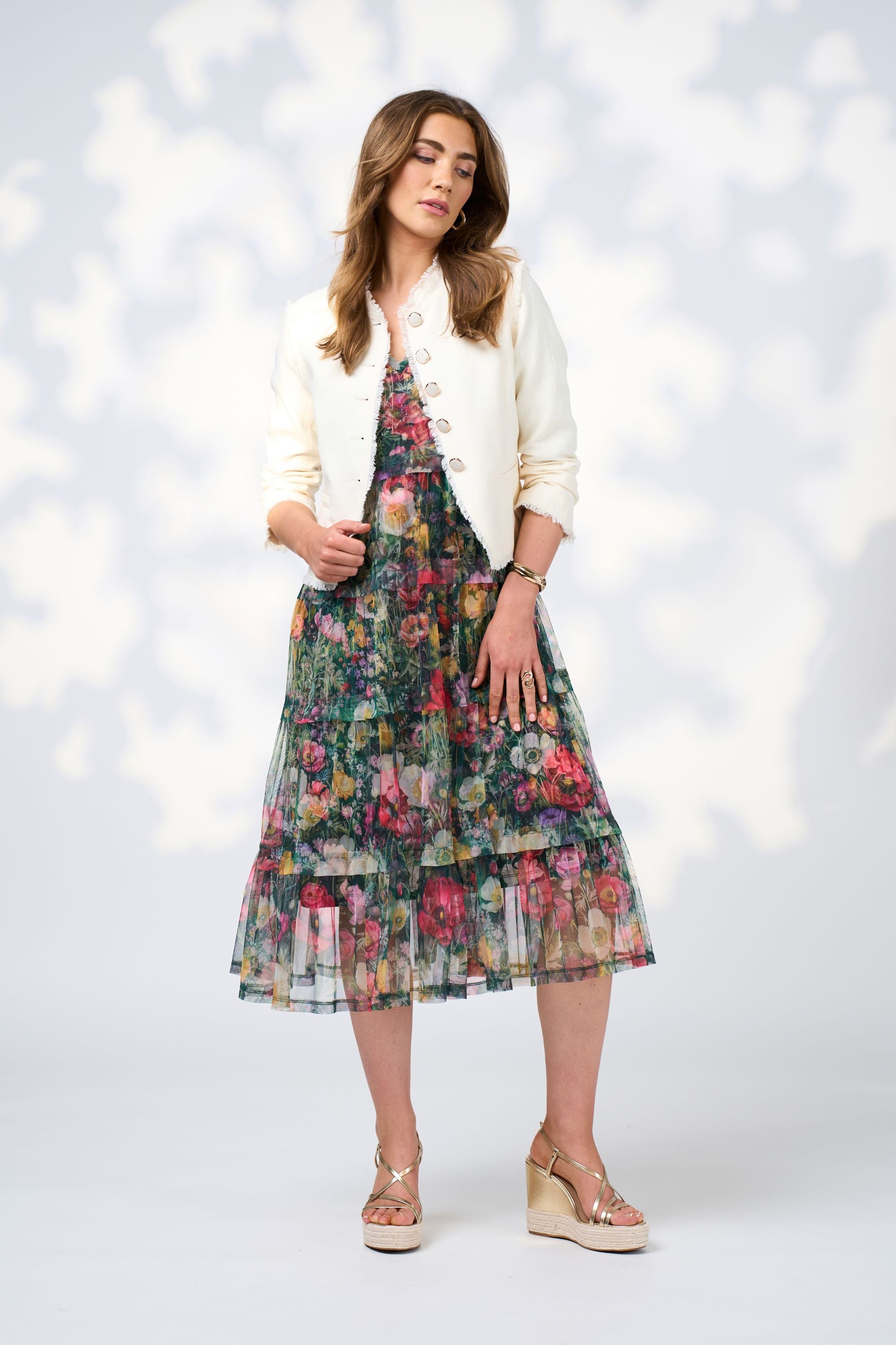 floral tulle layer midi dress and white jacket worn by model 