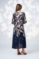 womens midi dress flowy skirt with long sleeve floral indigo worn by model back view