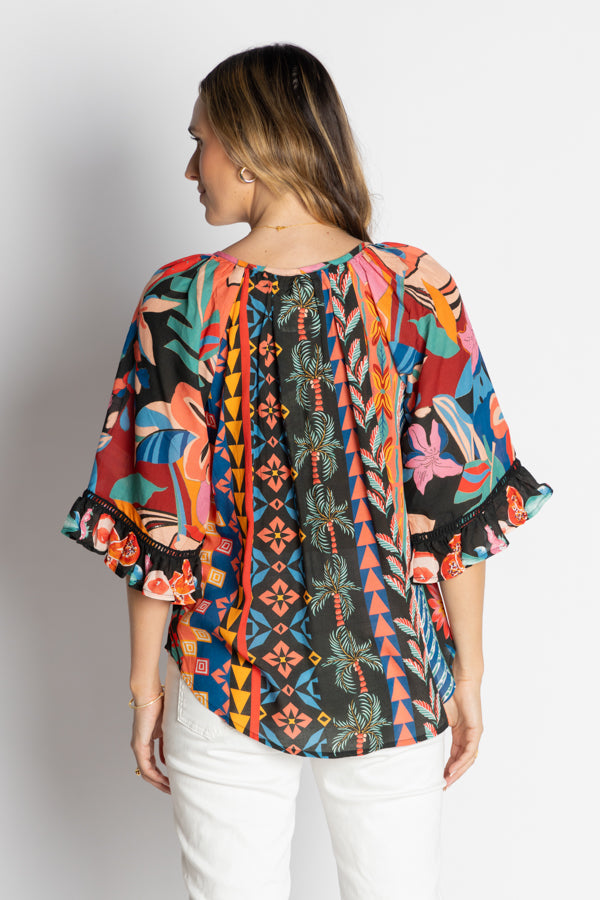 model wearing multi geometrical and floral print blouse back