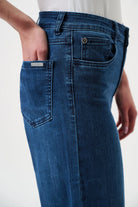Blue jeans worn by a person on a white background