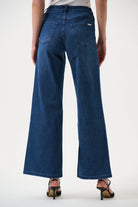 Blue jeans worn by a person on a white background back angle