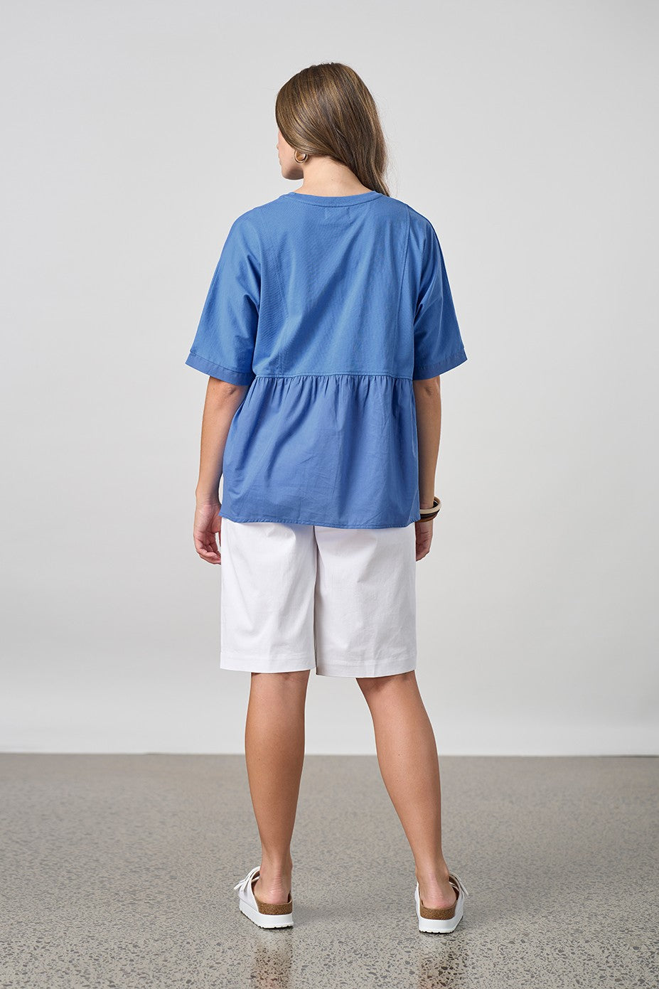 blue shirt with white short worn by model back view