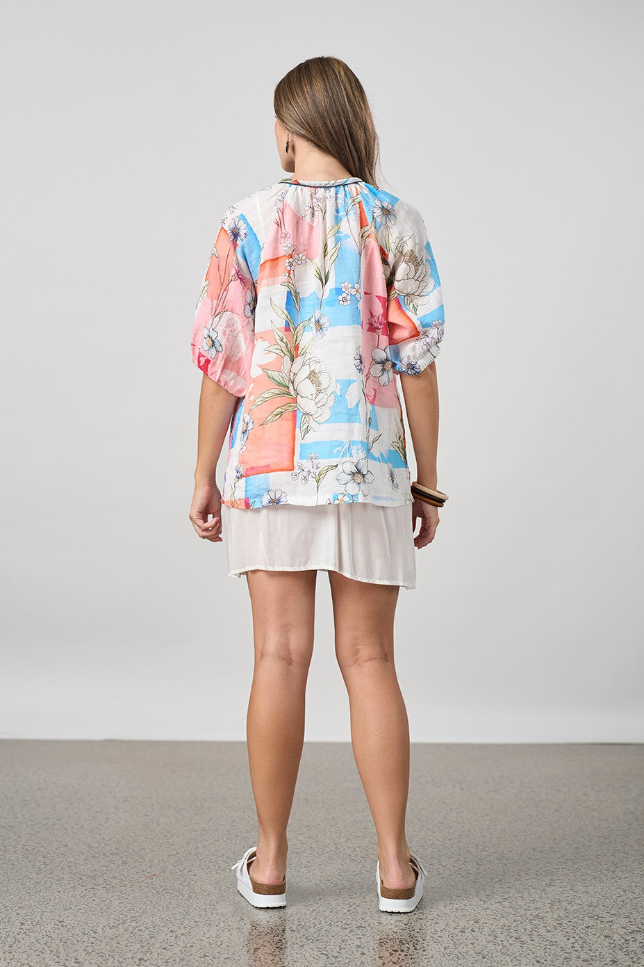 light floral blouse and short worn by model back view
