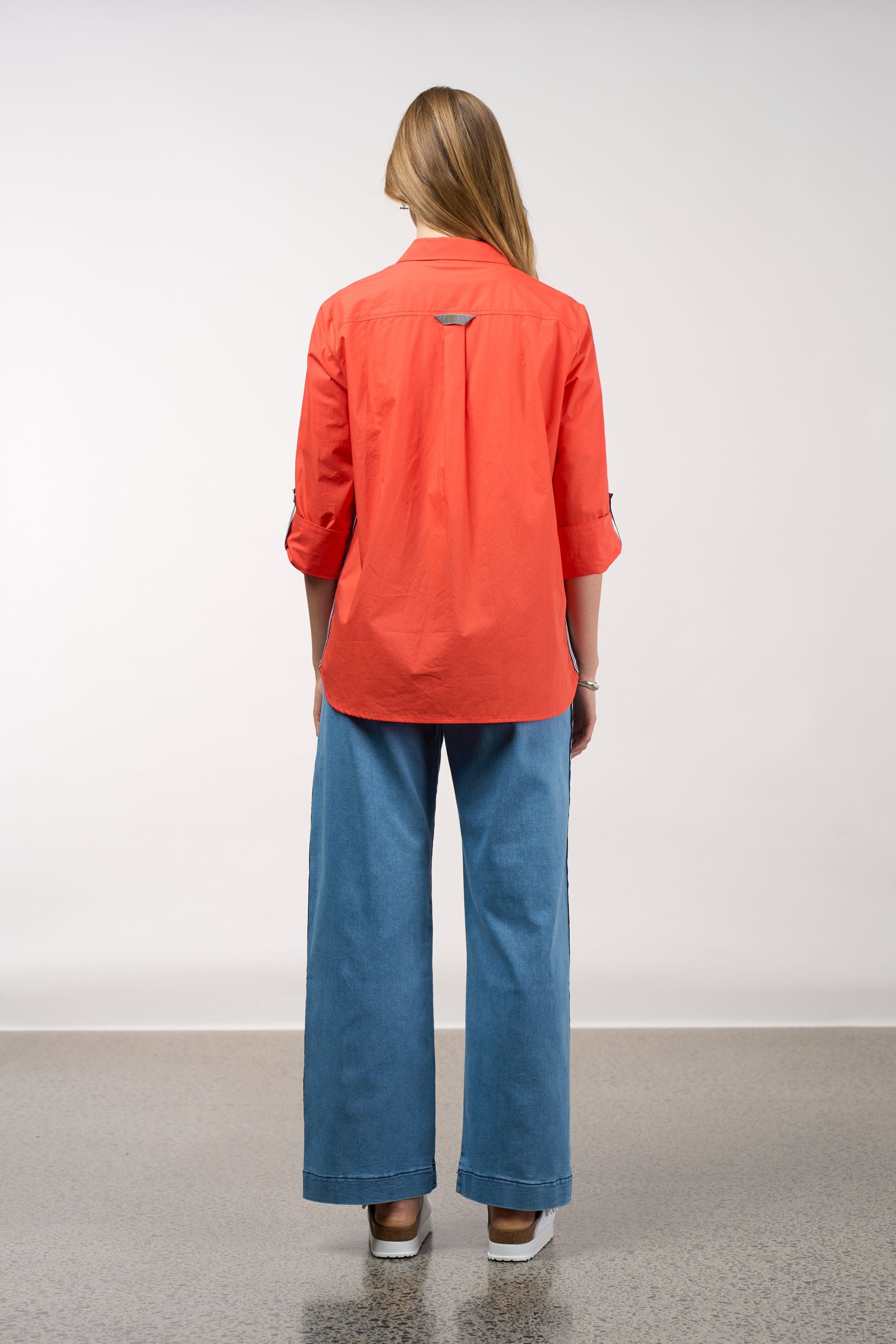 womens shirt orange with stripe trims worn by model back view
