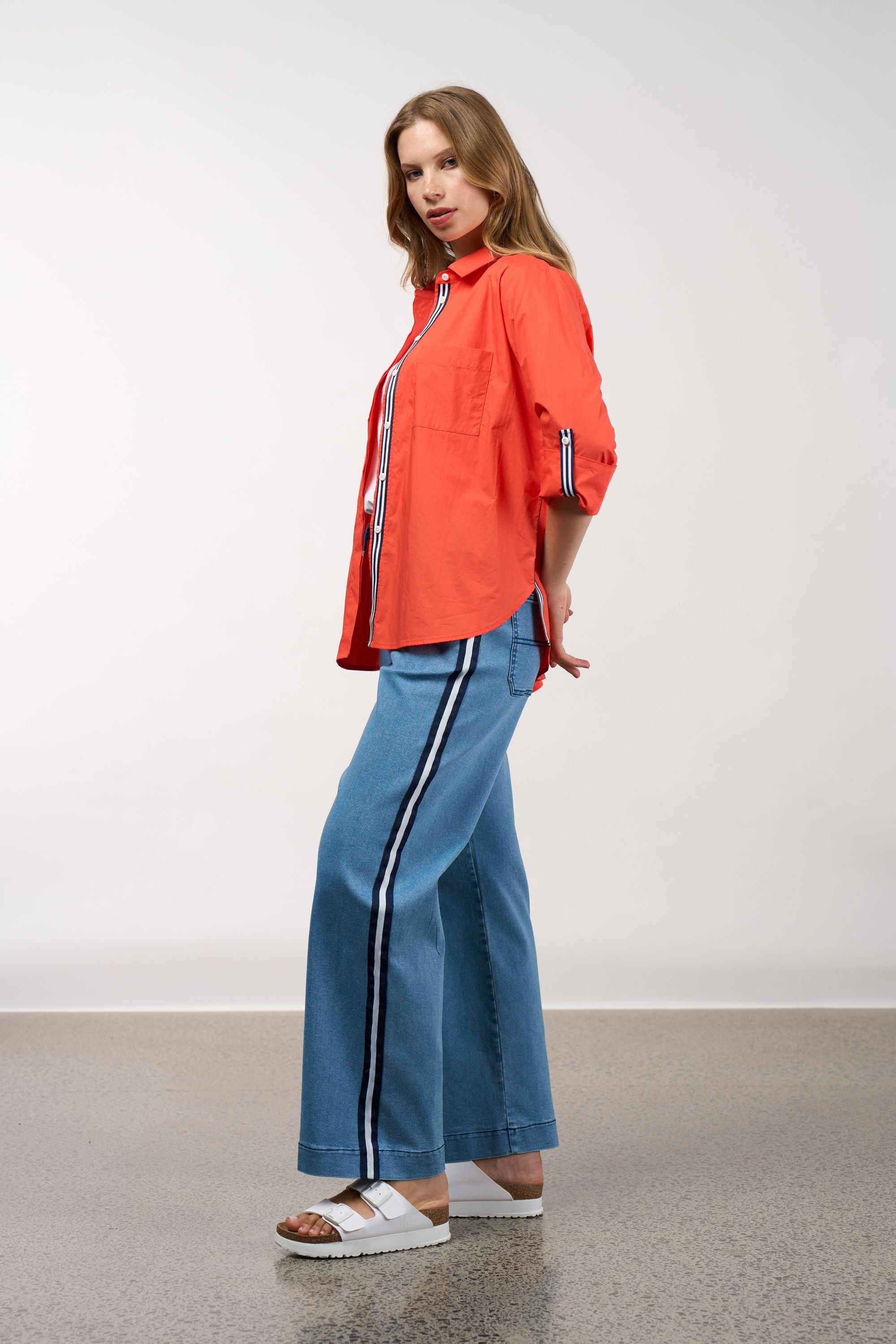 womens shirt orange with stripe trims worn by model side view