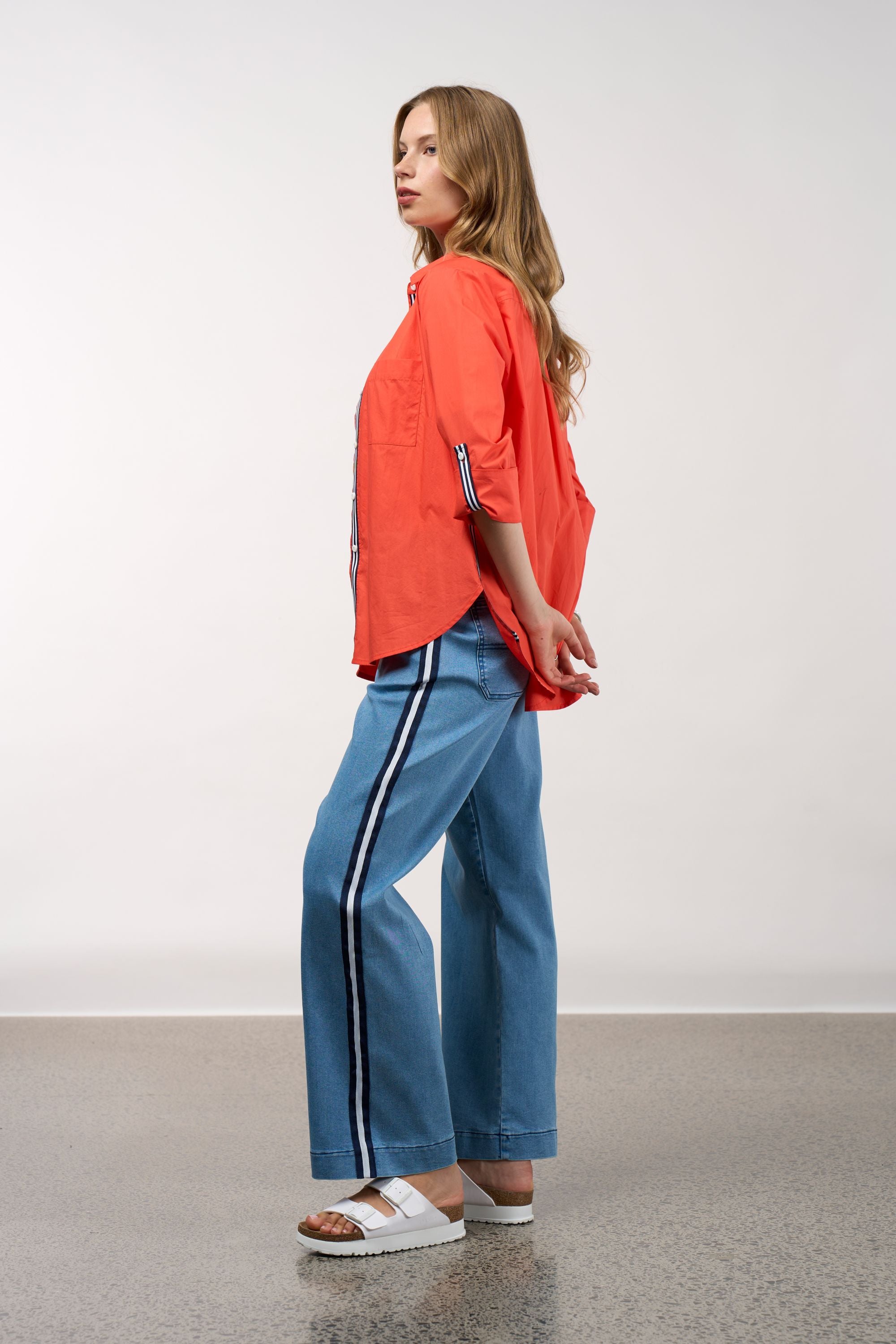 womens shirt orange with stripe trims worn by model side view