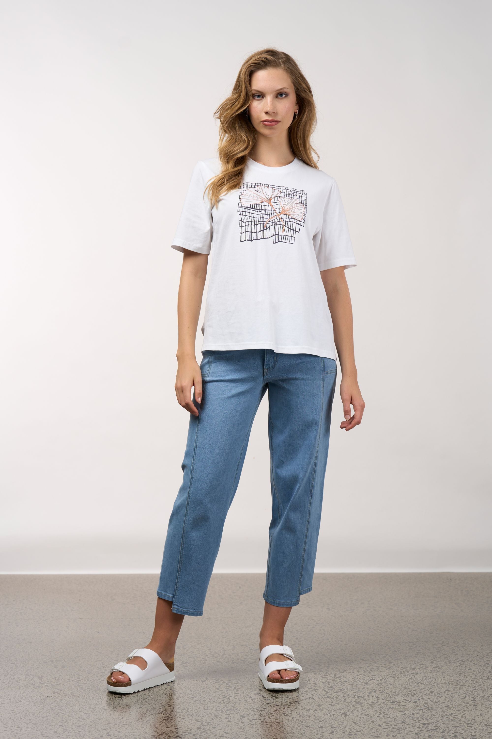 womens white tee with floral and grid line design worn by model