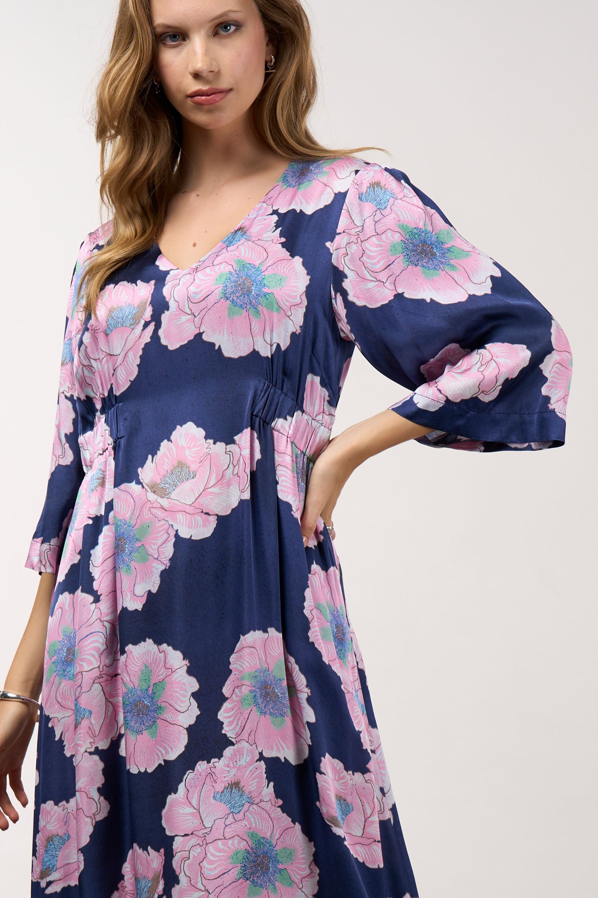 midi dress in navy with pink flowers worn by model close up