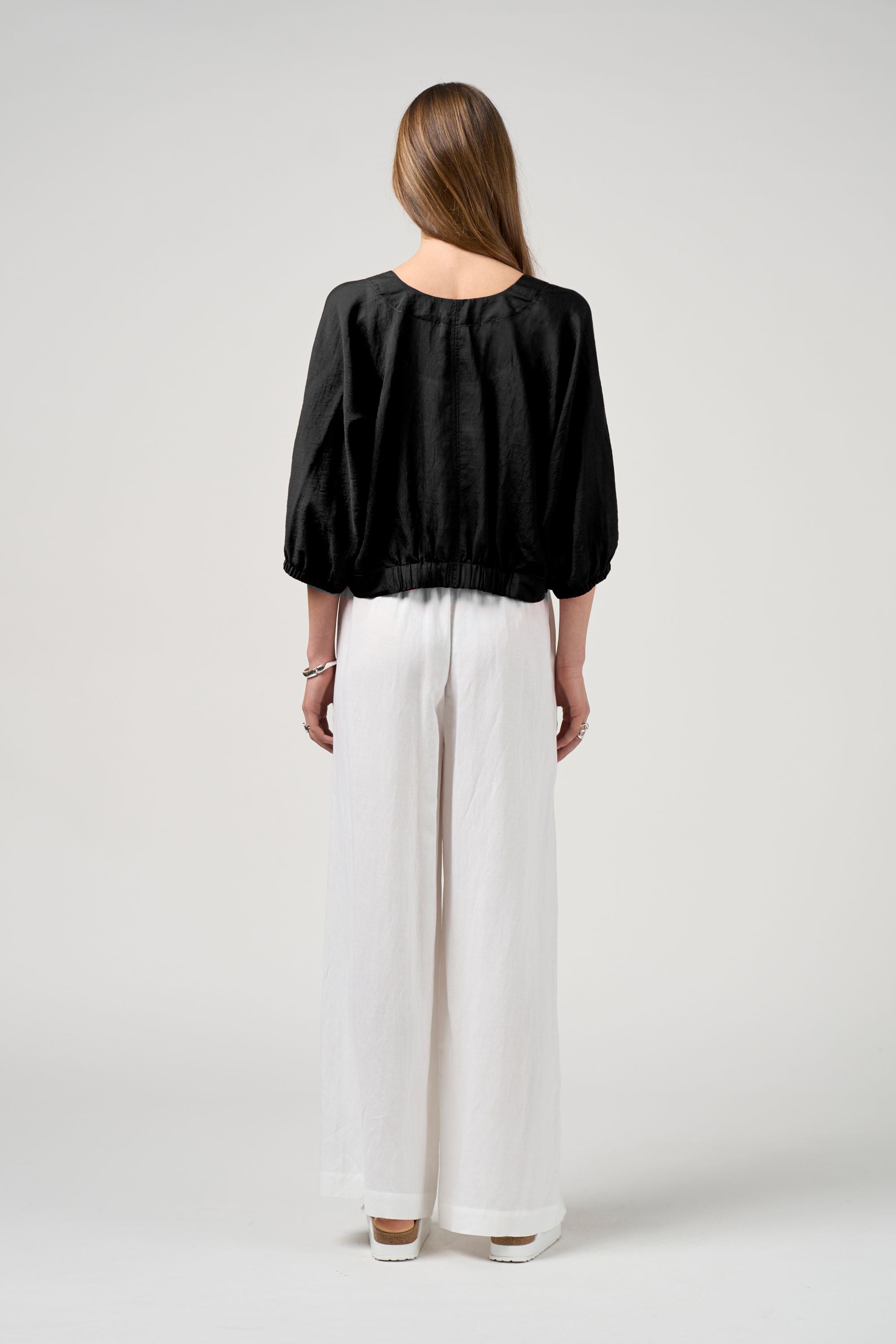 black tie jacket with white pant worn by model back view