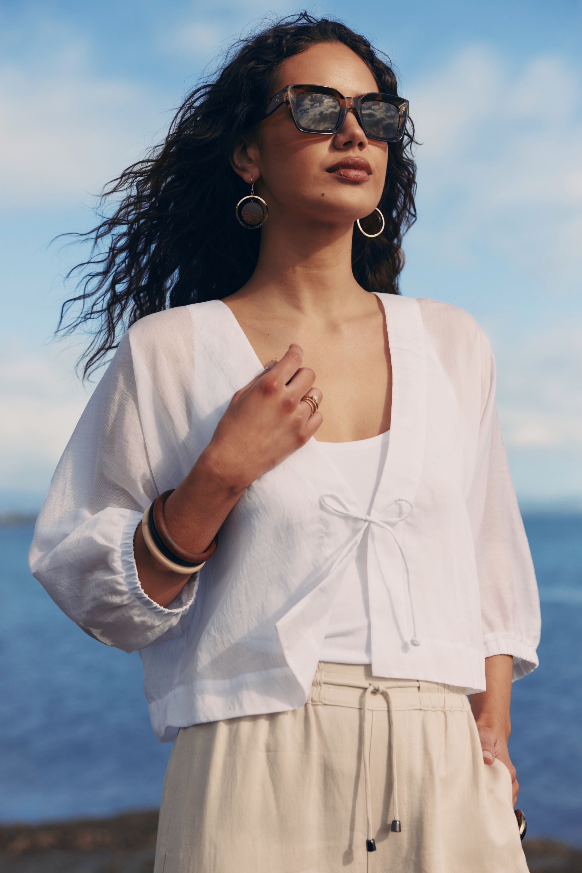 white tie jacket worn by model with ocean background
